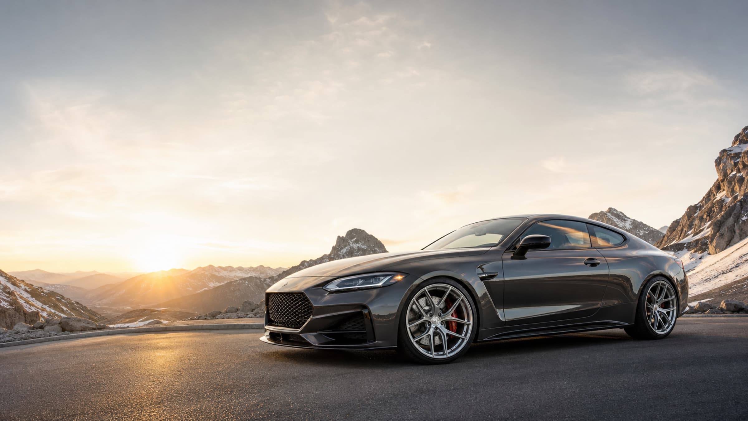 Luxury performance coupe with Everest forged wheels on an alpine road