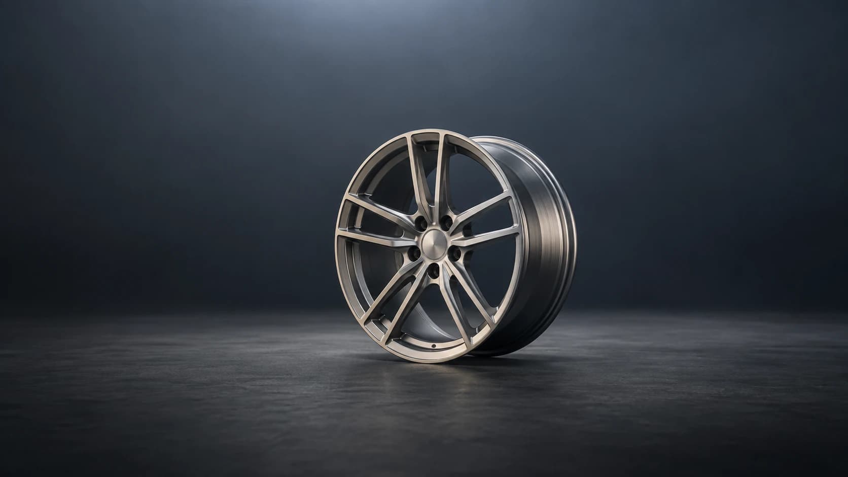 Brushed titanium forged wheel with machined split spokes in a graphite studio